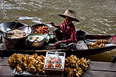 Thailand, Locals sell fruits, food and products at Damnoen Saduak floating market near Bangkok